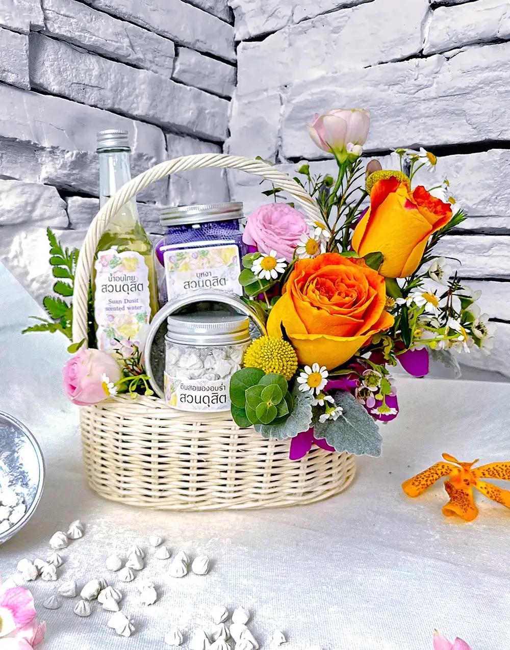 BS007 Fresh flower basket with Thai scented water set, adorned with warm orange flowers.
