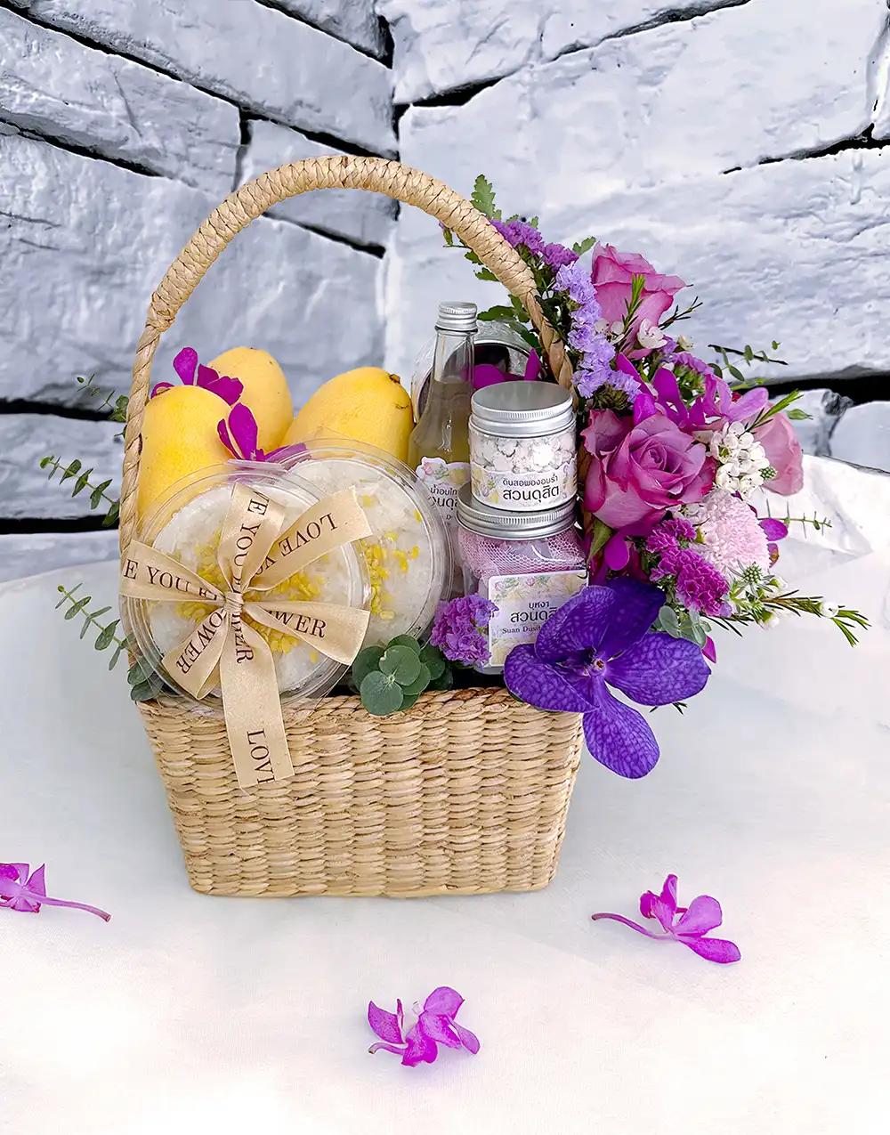 Songkran gift basket BFS007 with mango sticky rice and cooling Thai aroma set, adorned with purple flowers.