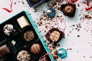 Various Valentine's Day chocolates are packaged in a blue box.