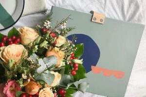 A bouquet of roses and a heartfelt card.